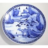 Large blue and white Chinese charger with depictions of temples