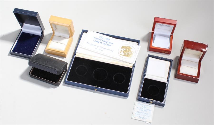 Gold proof coin set box, together with a Sovereign box and four jewellery boxes, (6)