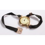 18 carat gold ladies wristwatch, with a white enamel dial and Arabic hours, manual wound