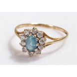 9 carat gold ring, with a central blue stone and surround to form a flower head