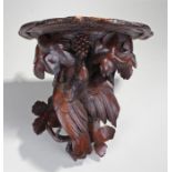 Early 20th Century black forest bracket, carved as a dove eating from grapes, 42cm high