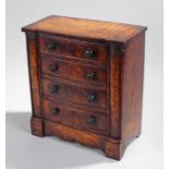 19th Century miniature elm chest of drawers, the top with projecting ends above four graduated