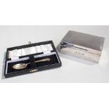 Silver cigarette box, London 1915, together with a cased silver spoon, Sheffield 1968, (2)