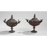 Pair of late 19th Century lidded urns, the acanthus leaf finial tops above flowers and petals, the