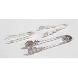 Silver sugar tongs, to include a sterling silver pair, a claw pair and a pair set with a Maltese