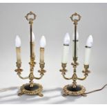 Pair of gilt brass table lamps, the red tapered shade with three sconces on a gadrooned base and paw