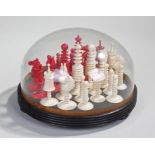 Late 19th Century ivory chess set, the ring turned pieces in red and natural, one pawn absent, the