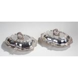 Pair of silver plated entree dishes, with acanthus leaf handles above acanthus leaf lids and