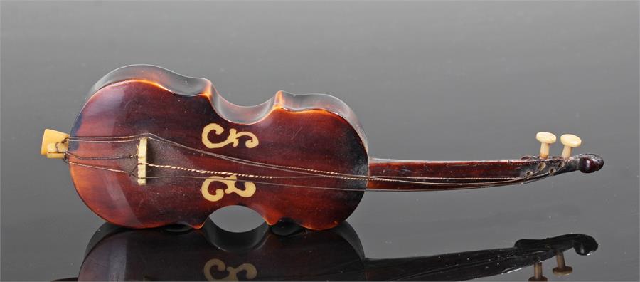 19th Century tortoiseshell sewing measure, in the form of a violin with the pull out tape measure to
