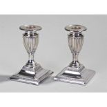 Pair of silver candlesticks of squat classical design with fluted urn shape stems, Sheffield 1891