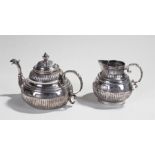 Continental silver teapot and jug, the teapot with a open-mouthed beast spout and acanthus leaf end,
