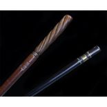 Two batons to include an Ebony example inlaid with ivory dots and brass ferrule and a mahogany