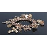 9 carat charm bracelet. with a collection of charms to include a church, a boot, a mug, a medallion,