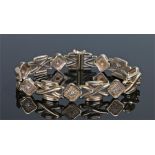 9 carat gold diamond set bracelet, each panel with a round cut diamond and cross design links, 22