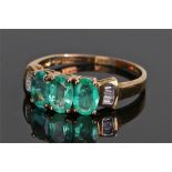 9 carat gold emerald and diamond ring, with three Zambian emeralds flanked by diamonds, ring size O