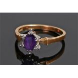 18 carat gold amethyst and diamond set ring, the central oval amethyst with six diamonds to the