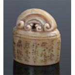 Chinese carved seal, the arched top above an oval body with Chinese characters, seal to the base,