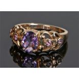 9 carat gold amethyst and pink tourmaline set ring, the central amethyst flanked by tourmalines,