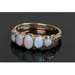 9 carat gold opal set ring, with a row of five oval opals, ring size N