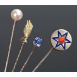 Collection of four stick pins, to include a hand, a blue enamel star, a pearl and a sapphire set