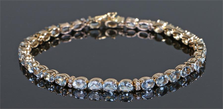 Aquamarine and diamond bracelet, with a row of thirty-four aquamarines and eighteen diamonds, 21cm