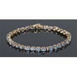 Aquamarine and diamond bracelet, with a row of thirty-four aquamarines and eighteen diamonds, 21cm