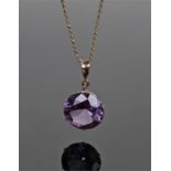 14 carat gold pendant necklace, the purple stone set within a pendant mount and 14 carat gold