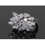 Platinum and diamond set ring, the cluster of diamonds to form a trailing flower head set with