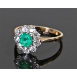 18 carat gold, emerald and diamond set ring, the round cut emerald 5.5mm in diameter with diamond