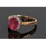 9 carat gold ruby and diamond ring, the central ruby at 2 carats with diamond surround, ring size O