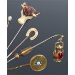 Collection of stick pins, to include a lamp, a horse shoe, a pearl, a bulls head and a disc with