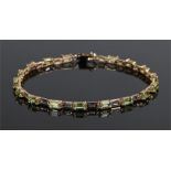 9 carat gold peridot bracelet, the bracelet with a row of emerald cut peridots, 19cm long