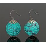 Pair of Chinese carved drop earrings, the green stone carved with swirls, yellow metal mounts,