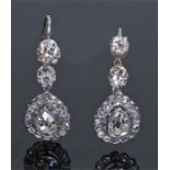 Pair of diamond drop earrings, the white metal earrings with round and pear cut drops, total