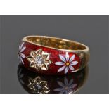 18 carat gold diamond and enamel ring, with a central diamond flanked by enamel flower heads to