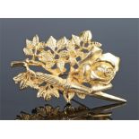 Rene Magritte gold plated brooch, with a dagger among a rose and branch, signed to the reverse, 70mm