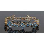 9 carat gold and blue topaz bracelet, the row of blue topaz to the gold bracelet, 18cm long