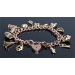 9 carat gold charm bracelet, the chain links with charms attached to include a racket, an urn, a