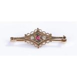 9 carat gold ruby and diamond brooch, with central ruby flanked by a diamond to each side, 2.3