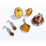 Amber and silver jewellery, to include two rings a pendant and a pair of earring, together with a