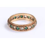 9 carat gold eternity ring, set with cubic zirconia and green stones