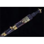 Scottish Dirk with Celtic knot grip contained in a brass mounted leather scabbard with knife and