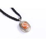 Silver and agate pendent, with a central orange agate with foliate surround