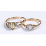 Two 9 carat gold rings, set with a pale blue stone, the second with a pale green stone, (2)