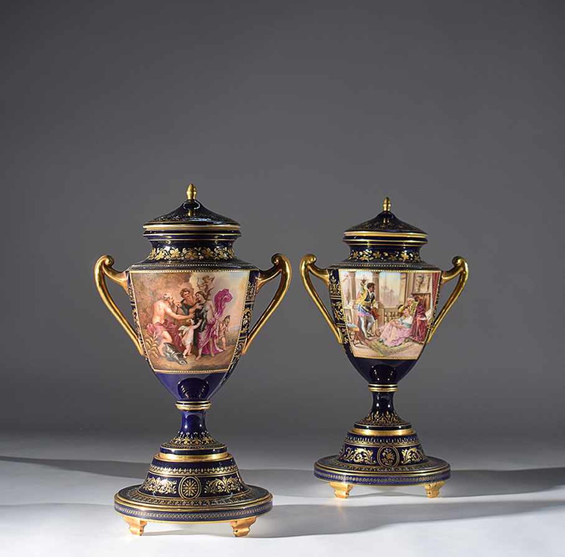 A pair of Vienna gilt and polychrome porcelain urns 19th century, 51cm. high. (one cover restored)