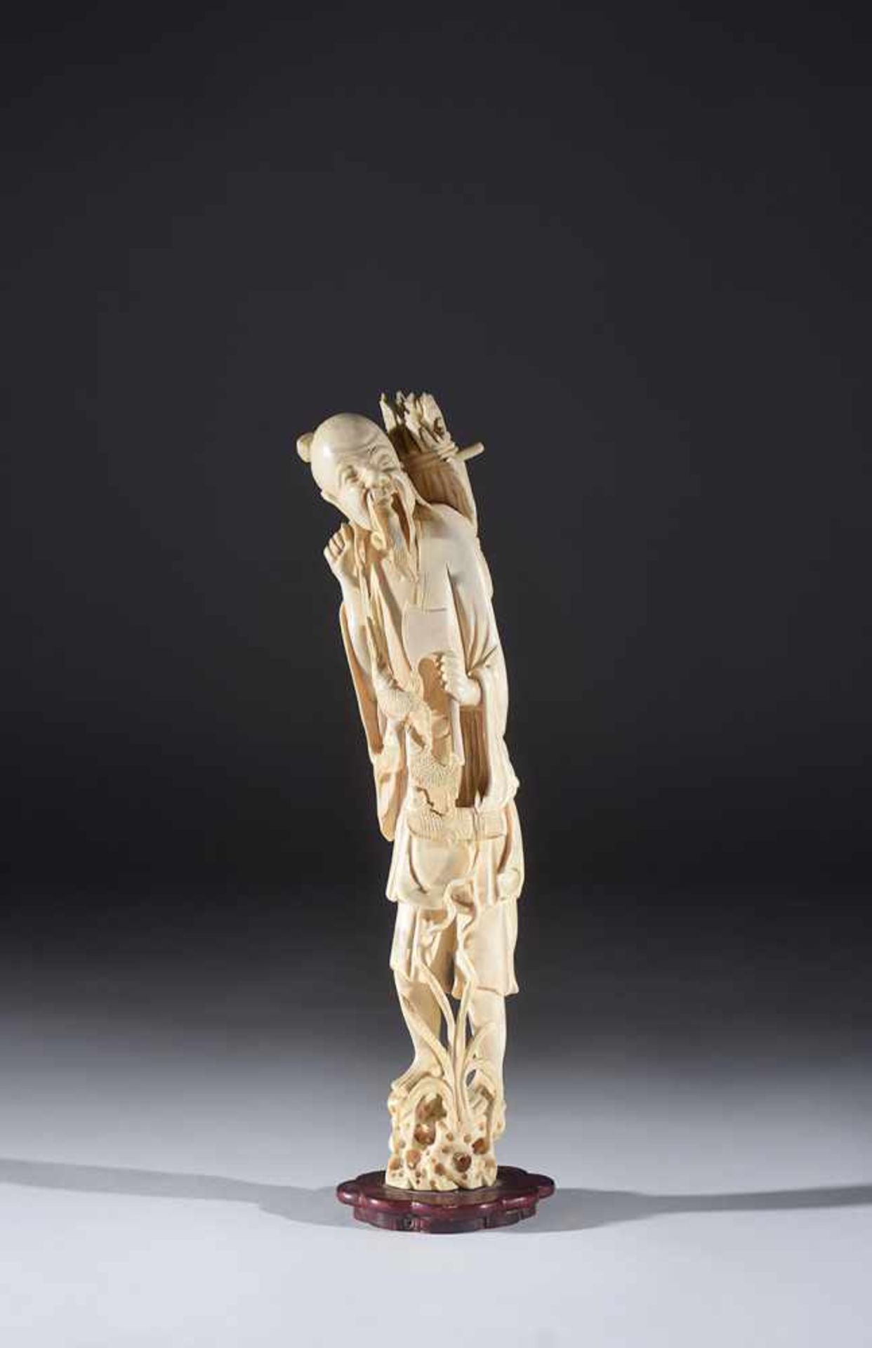 A Chinese ivory figure of a fisherman early 20th century, 31cm. high