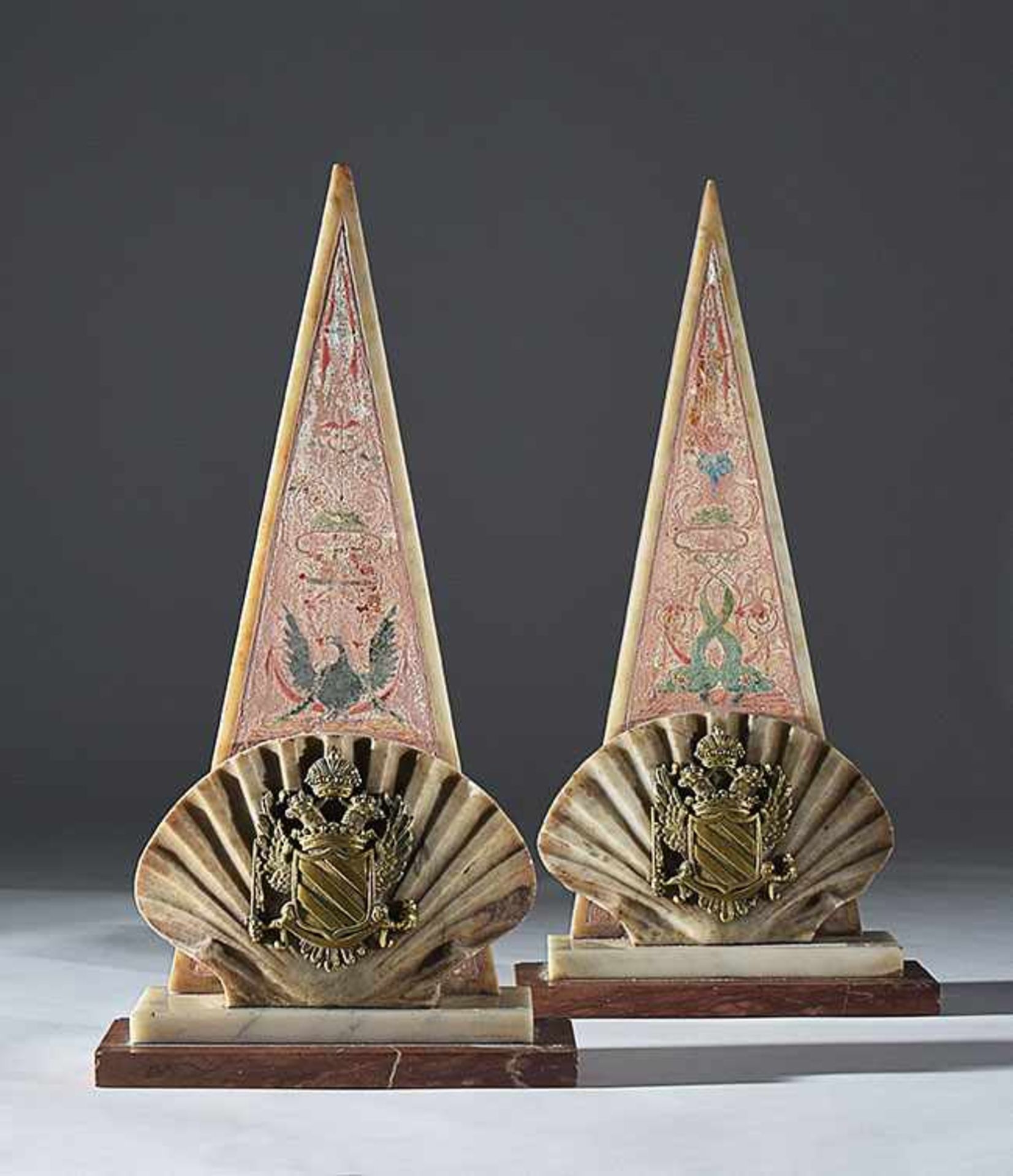 A pair of white marble and scagliola pyramidal decorations with a gilt bronze Russian imperial arms,