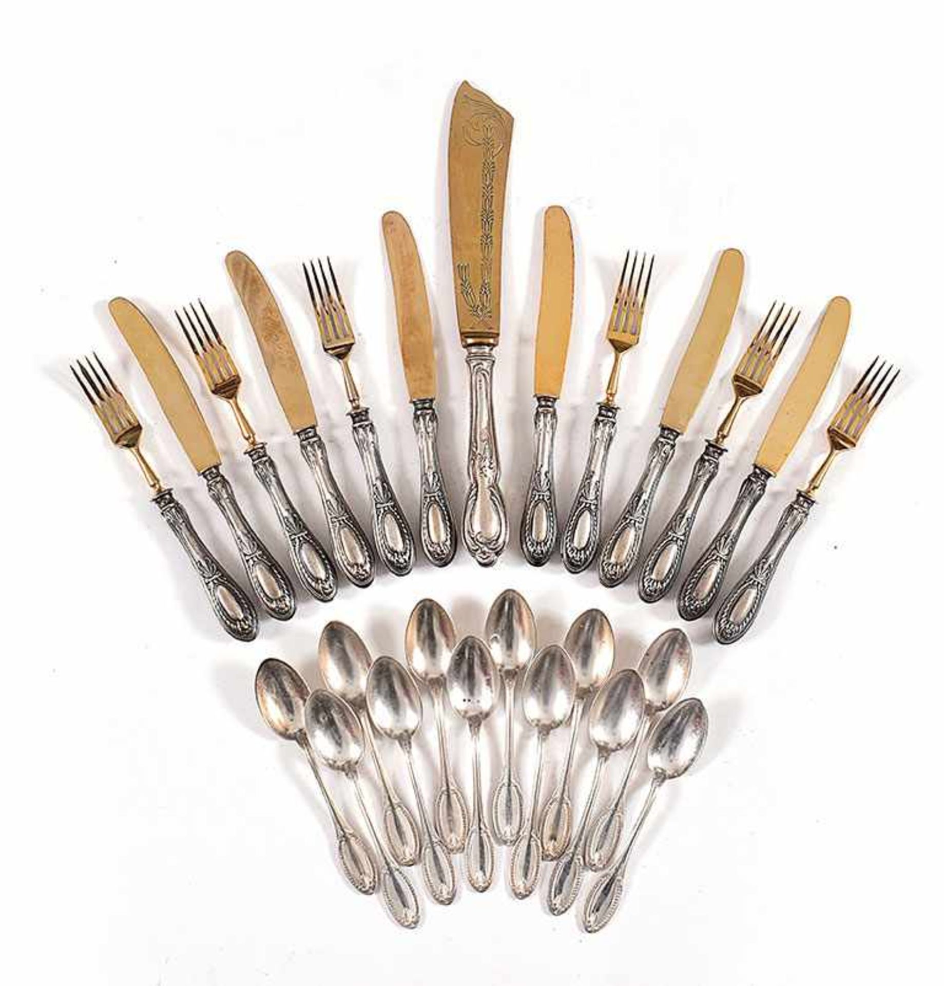 A silver and metal-gilt table silver service comprising: 12 dessert forks, 12 dessert knives