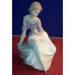 Large Nao figurine of lady sitting gazing at flower, 28cm tall