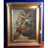 Oil painting of flowers in a vase ,with signature and fitted in a gilt frame.